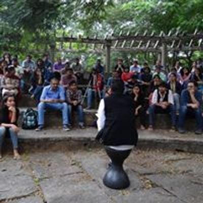 Poetry and Storytelling session under open sky on green grass.