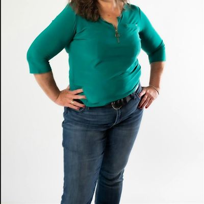 Laura FitzSimmons with Wild and Unbridled Coaching logo