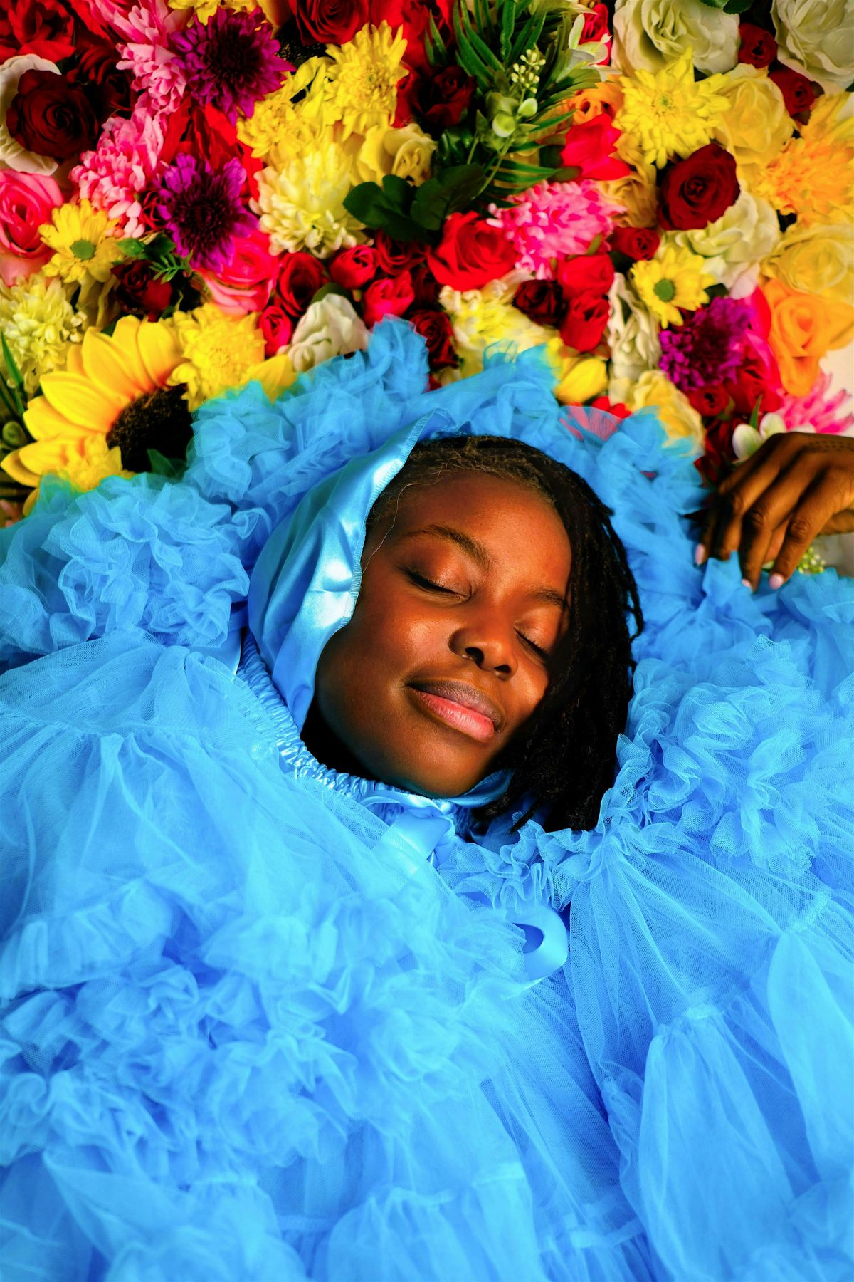 A vibrant workshop scene where participants engage in reclaiming portrait photography through floral and natural elements, symbolizing the fusion of nature and self-expression.